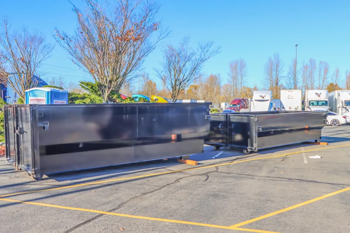 Professional dumpster rental service with roll-off container on residential driveway in Bogalusa